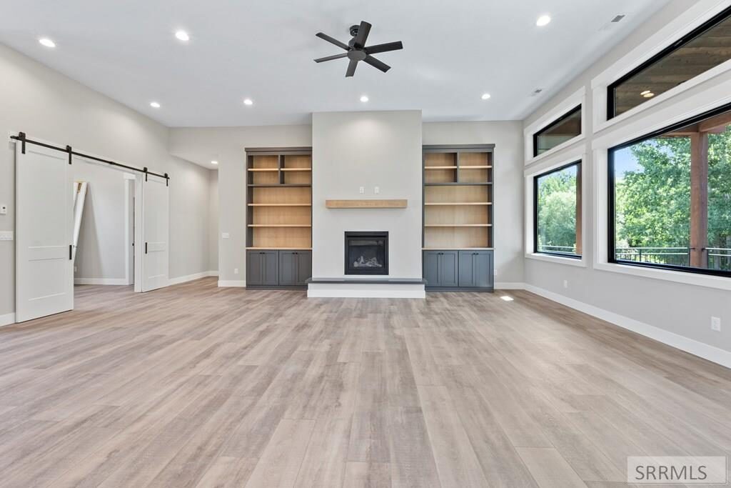 Living room facing fireplace and barn door