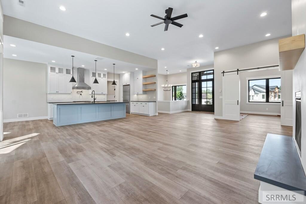 Open floor plan view of kitchen, dining, and living